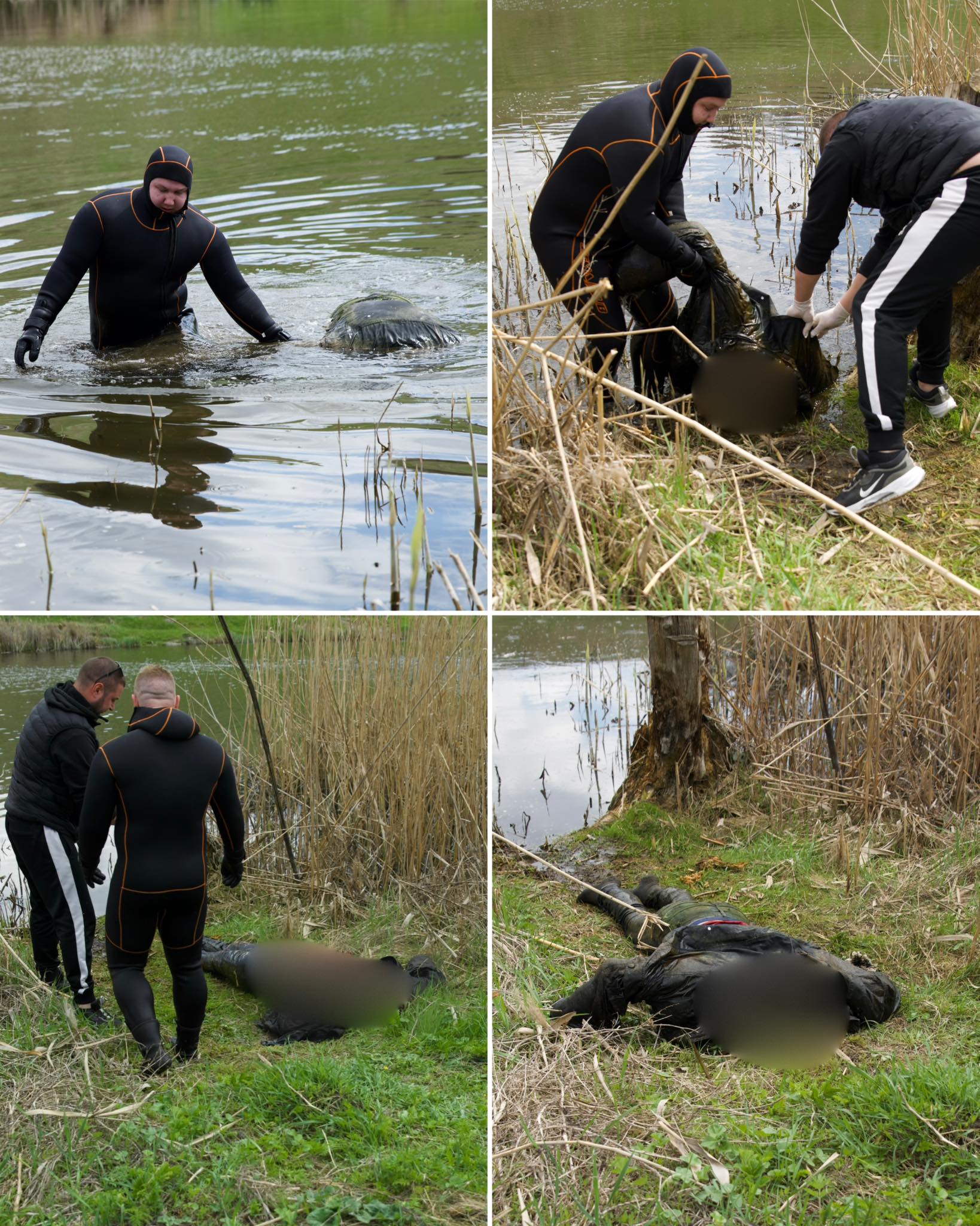 People in black wetsuits with orange trim wade in a calm pond, gathering items from the water’s edge.