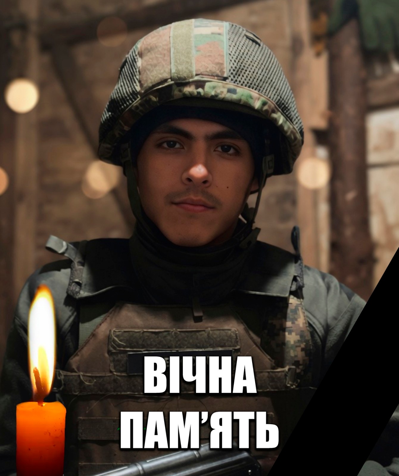 Soldier in camouflage gear holding a lit candle during a memorial, with the Ukrainian phrase 'Вічна пам’ять' visible at the bottom.