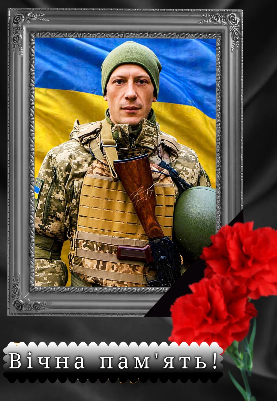 Portrait of a camouflage-clad soldier in front of a Ukrainian flag, framed as a memorial with red carnations and the caption 'Вічна пам'ять!' (Eternal memory).