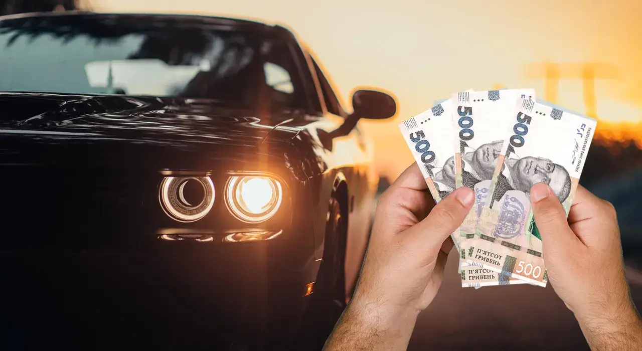 Hands hold a fanned stack of 500-denomination banknotes in front of a black car with its headlights on at sunset.
