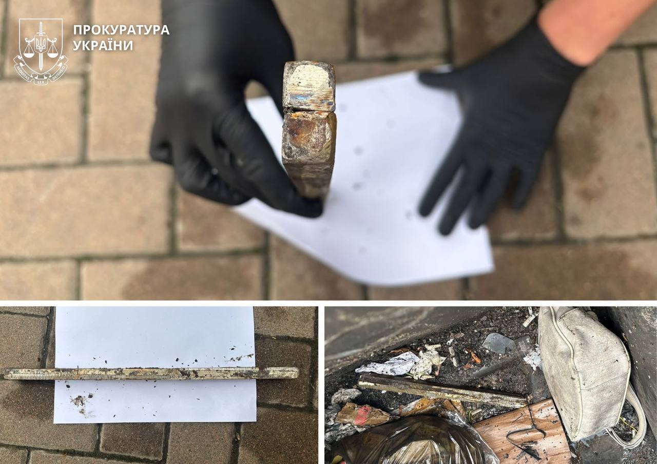 Evidence photos from a investigation: a gloved hand holds a dirty, rusty hammer above a sheet of paper on a brick surface; watermark in corner indicates Ukrainian Prosecutor’s Office.